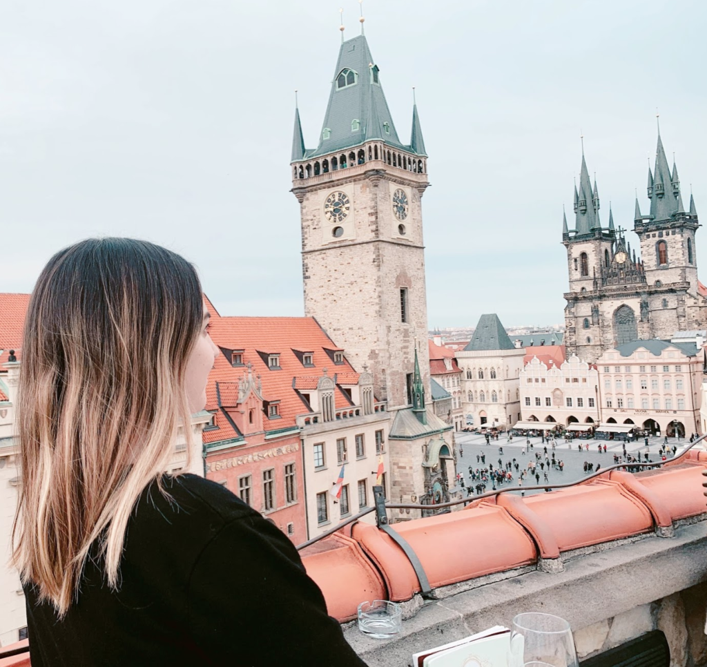 Photo of a girl overlooking a castle in Prague